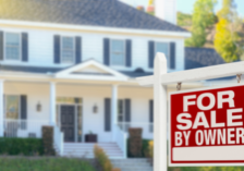 for sale by owner sign in front of a house