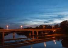 bridge over a river lit up for night